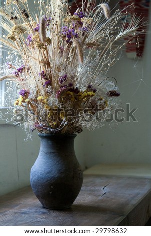 Ð¡lay vase with dried flowers