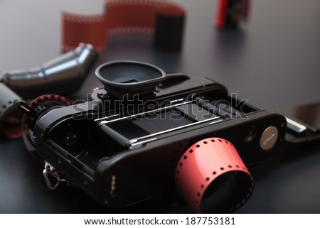 35mm analog reflex camera lying down on its roll film