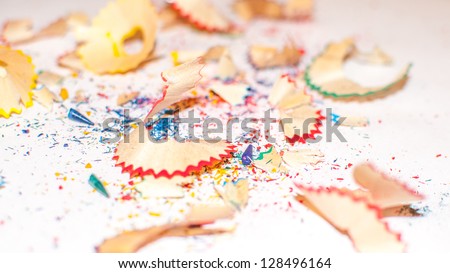 multicolored wood shavings from a pencil close up with fragments of graphite