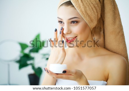 A beautiful woman asia using a skin care product, moisturizer or lotion and Skincare taking care of her dry complexion. Moisturizing cream in female hands