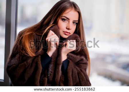 Fashion Winter beauty in fur coat over black