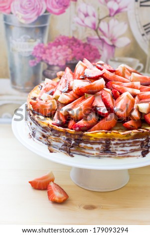 Crepes cake with strawberry and chocolate sauce