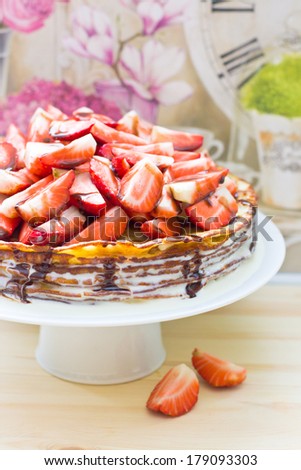 Crepes cake with strawberry and chocolate sauce