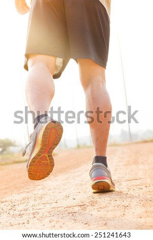 running sport feet on trail healthy lifestyle fitness.  sunset jogging workout wellness concept.