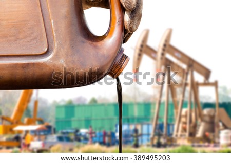 pouring crude oil from sample canned oil pump background. crude oil low price concept.