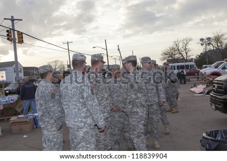 NEW YORK -NOV 12: US Army helping Hurricane Sandy victims move a debris and parts of destroyed houses in the Breezy Point on November 12, 2012 in the Queens,  NY