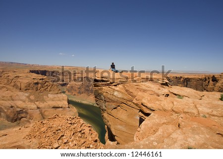 Girl on a top of a rock enjoying the desert panorama