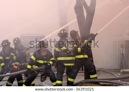 QUEENS,  NY - FEBRUARY 12: Firemen on duty fight fire on February 12, 2009 in Queens, New York.