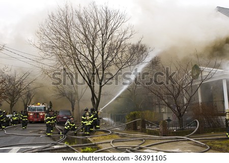 QUEENS,  NY - FEBRUARY 12: Firemen on duty fight fire on February 12, 2009 in Queens, New York.