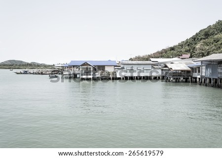 Thailand Fishing Village with a boat in the harbour.