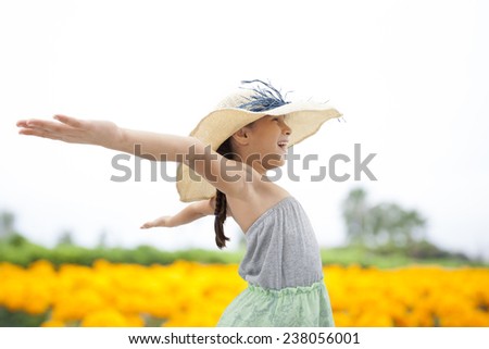 Little girl with arms wide open on nature