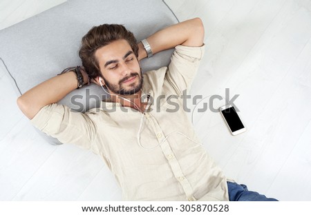 Young man listing to music with mobile phone
