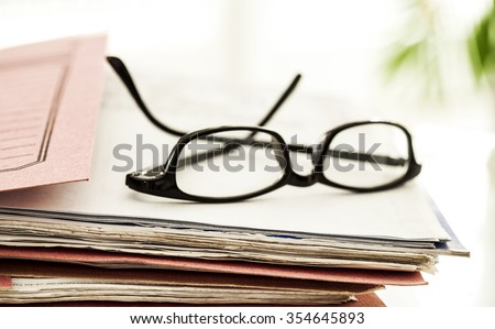Business file and eyeglasses