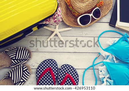 Ready vacation suitcase on wooden background