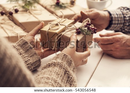 Woman gives gift in box
