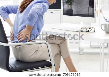 Businesswoman with pain in back