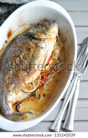 Dorado fish baked with vegetables.