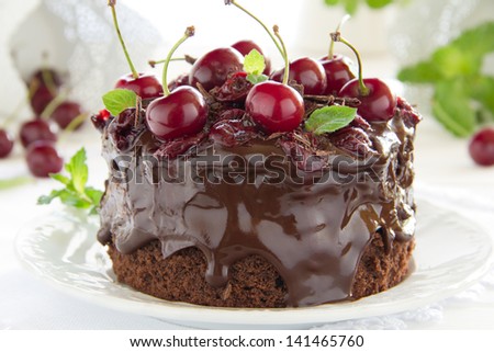 Chocolate cake with cherries and chocolate cream.