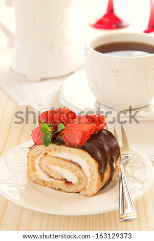 Chocolate swiss roll cake with strawberries