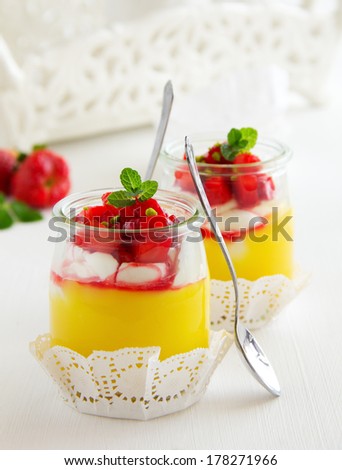 Dessert in a jar with lemon cream, strawberries and granola