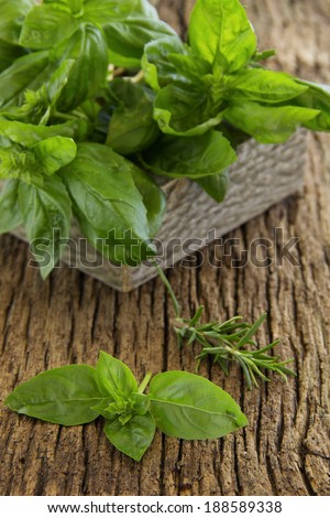 Bunch of basil on the old board. Selective focus.