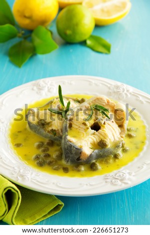 Hot lunch vapor sturgeon with lemon sauce and capers.