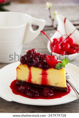 Slice of cheesecake with strawberries and strawberry sauce.