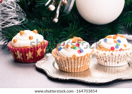 Christmas cupcakes, spruce branches and christmas decorations