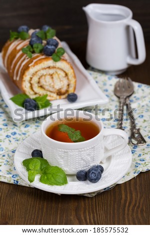 Sweet Biscuit Roll Cake with fresh berries and a cup of tea.