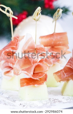 Melon with Prosciutto Snack on Christmas decorated plate