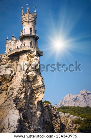 Castle on the cliff by the sea with a beautiful sun. Swallow\'s Nest Castle Ukraine Crimea mountain