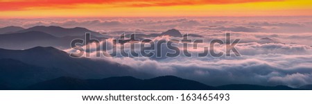 Beautiful sunrise above the Crimea mountains with a cloudy valley