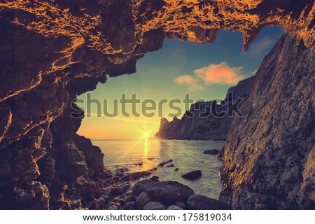 Vintage sea sunset from the mountain cave