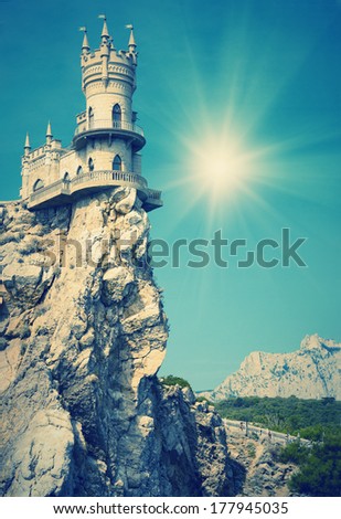 Vintage picture. Castle on the cliff by the sea with a beautiful sun. Swallow\'s Nest Castle Ukraine Crimea mountain