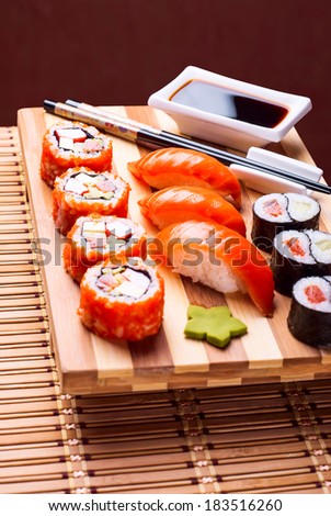 sushi and rolls on a bamboo geta