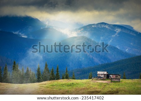 Sunrise above the nature Ukrainian wooden houses in a Carpathian mountains.
