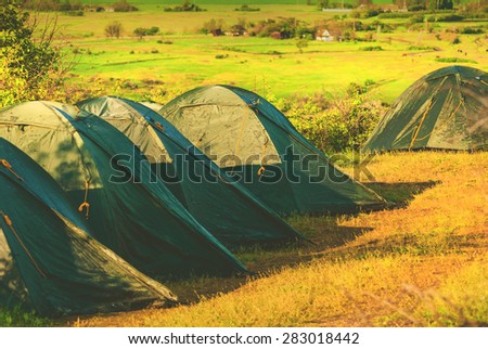 Camping tents in a valley of Ukrainian National park. Selective focus.