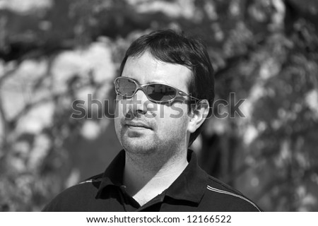 Young Guy With Sunglasses Looking off Camera on Vacation