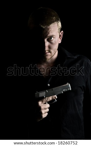 Intimidating Male Holding a Gun to his Chest