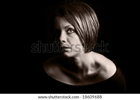 Attractive Brunette Looking Off Camera against Black Background