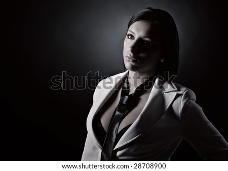 Low Key Shot of an Attractive Brunette in White Suit and Tie
