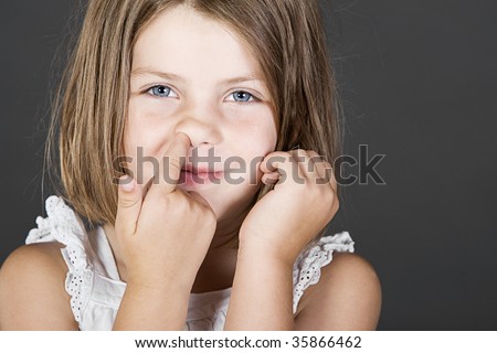 stock photo Shot of a Cute Blonde Child Picking her Nose