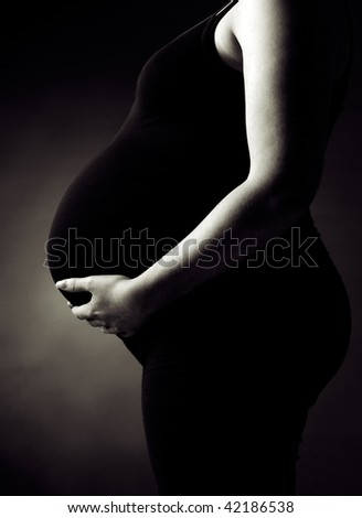 Black and White Profile of a Pregnant Woman Supporting her Belly