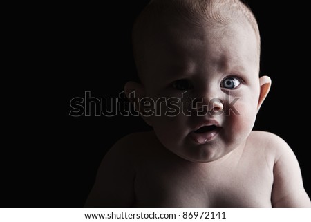 Low Key Shot of a Scared Looking Infant