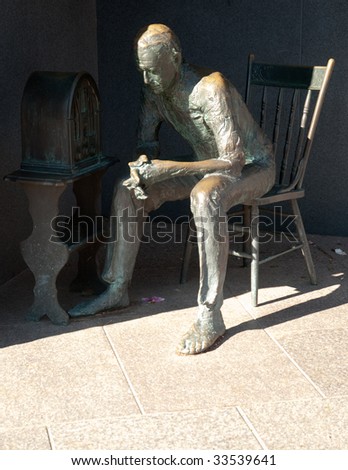 man listening to radio statue