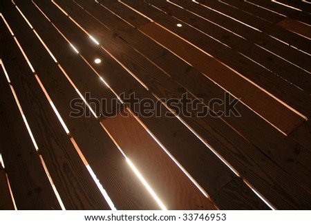 light shining through wooden floor boards