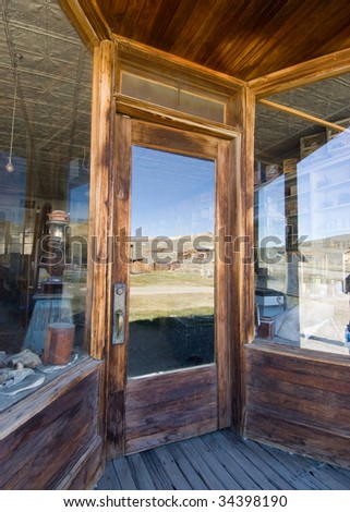 reflection of a ghost town in a shop window