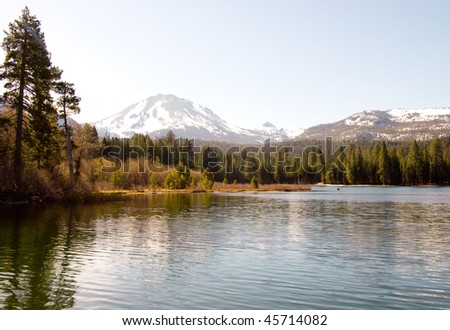 Summit Lake, pine forest and snow covered volcanic mountains
