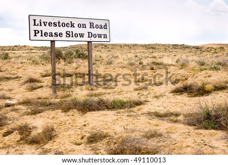 Livestock on Road Please Slow Down sign
