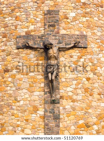 Jesus on the cross made of brick on the side of a church